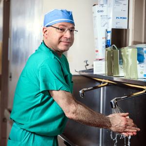 Portrait of Dr. Jeffrey Ferris washing his hands at a scrub sink outside of an operating room at MedStar Franklin Square Medical Center.