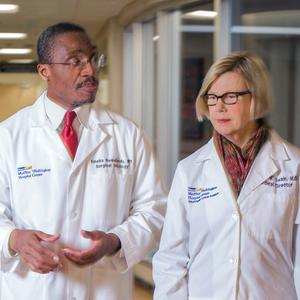 Doctors Ihemelandu and Swain talk while walking through the hallway at MedStar Washington Hospital Center.