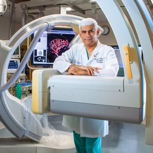 Dr Arshad Khan stands in an interventional radiology lab at MedStar Health.