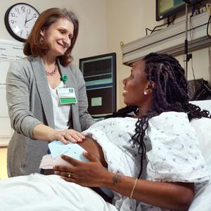 Loral Patchen, MedStar Health midwife, vists with a patient in her hospital room.