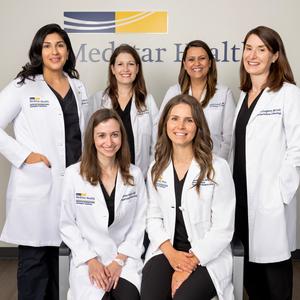 A team of physicians from the MedStar Health headache center smile as they pose for a group photog.