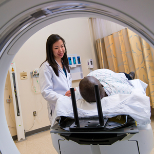 A doctor talks with a patient who is about to undergo diagnostic radiology.