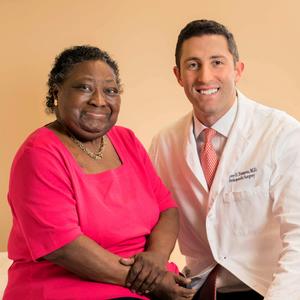 Dr. Oliver Tannous, spine surgeon at MedStar Health, poses for a photo with a patient.