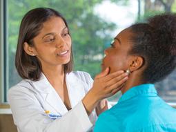 Endocrinologist Susmeeta Sharma examines a patient in a clinical setting.