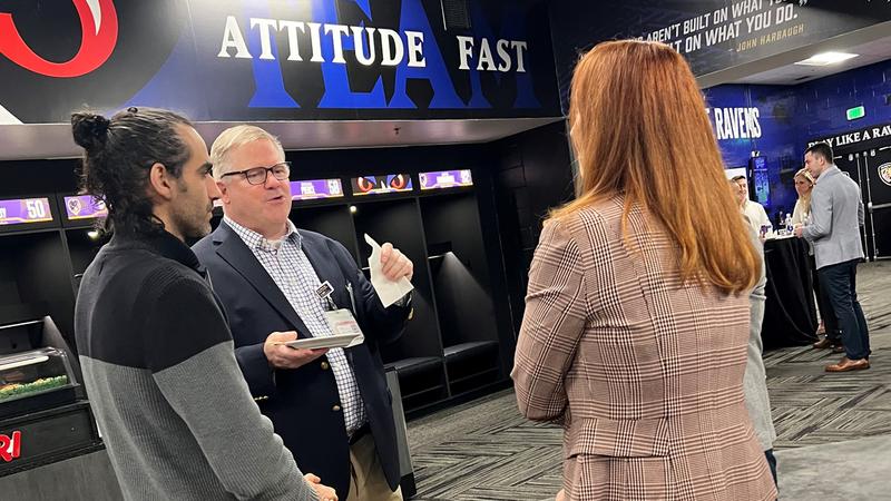 Dr Steve Svoboda talks with attendees at a Medstar Health Sports Medicine Fellowship Reception at M&T Bank Stadium.