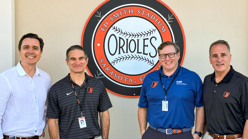 Group photo of MedStar Health sports medicine physicians and a sports medicine fellow at Orioles training camp.