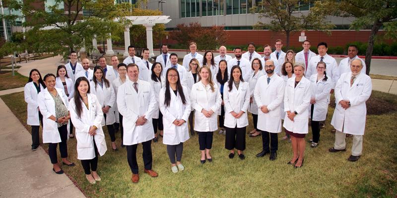 The faculty of MedStar Health General Surgery Program in Baltimore, wear masks and stand together for a photo outside of the Surgical Pavillion at MedStar Franklin Square Medical Center.