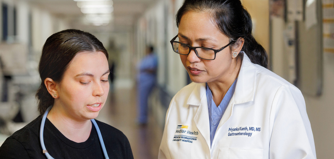 Dr. Priyanka Kanth consults with a nurse in a hospital hallway at MedStar Health.