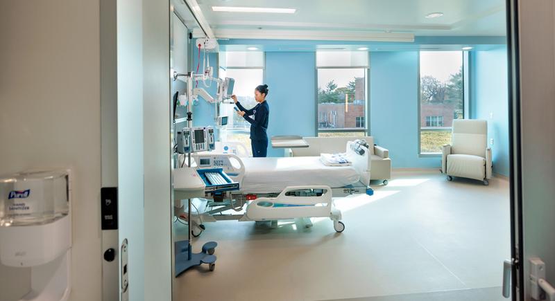 A nurse works on the equipment in a patient room at the Verstandig Pavillion at MedStar Georgetown University Hospital.