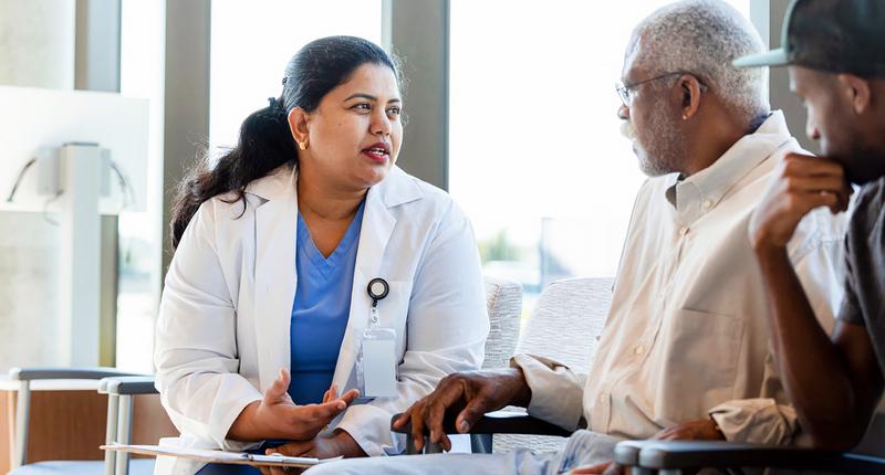 A doctor talks with a patient's family in a hospital waiting room.