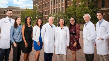 A group of faculty from the Infectious Disease Fellowship Program at MedStar Georgetown pose for a group photo outdoors.