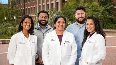 A group of fellows from the Infectious Disease Fellowship Program at MedStar Georgetown pose for a group photo outdoors.