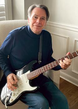 Randy Hemmingway, a MedStar patient, plays a guitar at his home.