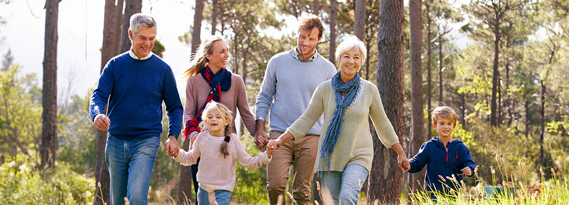 Happy multi-generation family walking in the countryside