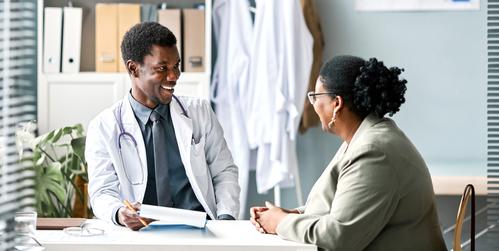 A doctor consults with a patient in an office setting.