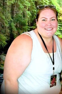 MedStar Health bariatrics patient Sarah Thompson smiles for the camera while hiking in the woods.