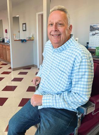 Alvin Tippett Jr sits in a chair in his barber shop after undergoing successful bariatric surgery treatment at MedStar Health.
