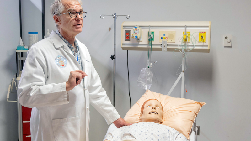 John Yosaitis with medical mannequin at SiTEL Sim Lab