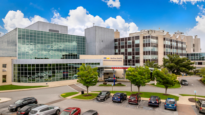 Aerial view of MedStar Good Samaritan Hospital - a modern blue-green glass and concrete building in Baltimore, Maryland.