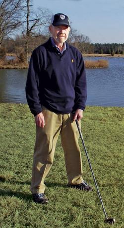 Jack Yeatts poses for a photo on the golf course, after undergoing successful proton therapy at MedStar Georgetown University Hospital.