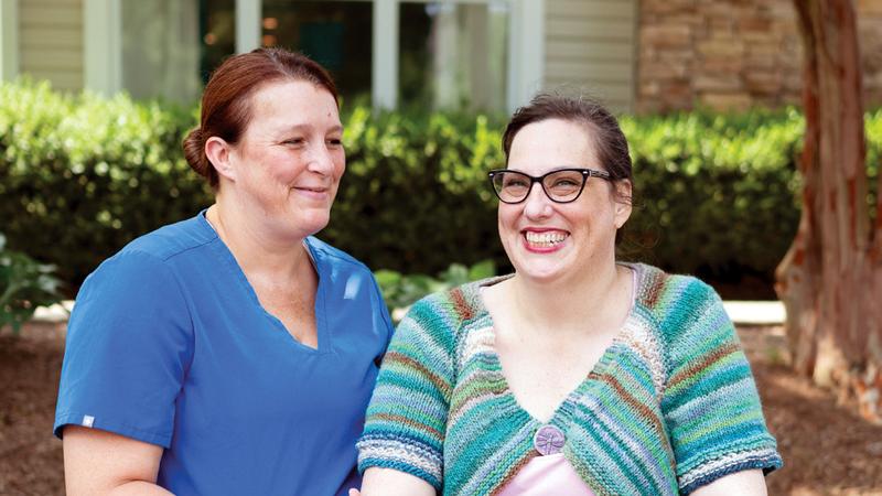 A nurse stands with Jennifer Crow who underwent successful treatment for sepsis at MedStar Health.