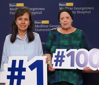 Martha Ramos and Kathleen Norris pose for a photo with the 1st and 100th patients treated with proton therapy at MedStar Georgetown University Hospital.