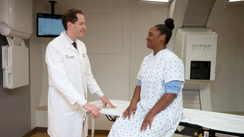 Dr Keith Unger consults with a female patient in the Proton Therapy center.