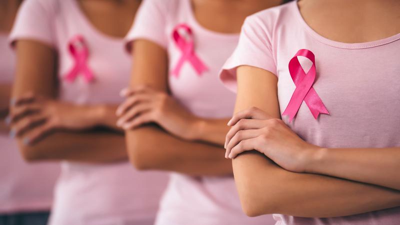 Cropped image of group of young multiracial woman with pink ribbons.