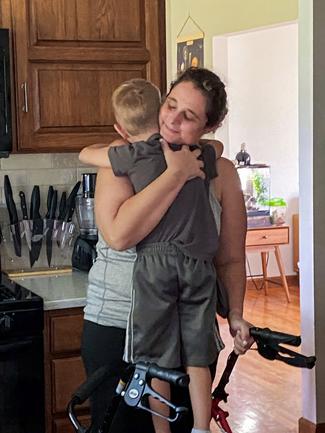 Jen McNally hugs her son, Izzy, after returning home after 22 days of hospitalization at MedStar Health.