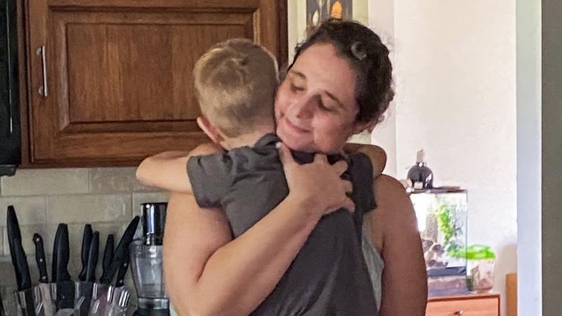 Jen McNally hugs her son, Izzy, after returning home after 22 days of hospitalization at MedStar Health.