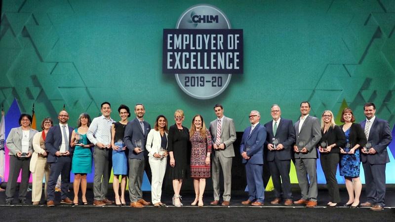 Emergency physicians receive an award on a large stage.