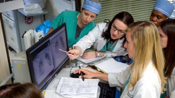 Doctors and nurses from MedStar Health's burn team consult together at a computer.