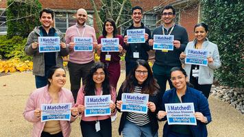 A group of graduates from MedStar Health's Internal Medicine Residency program in Washington DC hold a sign indicating where they matched for continued training.