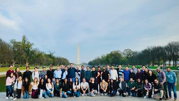 A group of residents from MedStar Health's Internal Medicine Residency Program in Washington DC pose for a casual group photo on the steps of the Lincoln Memorial.