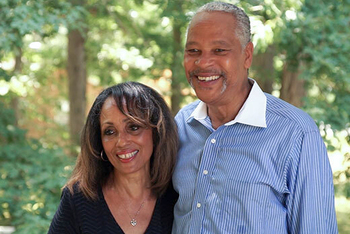 Euvon Jones and his wife pose for a photo outside with trees in the background.