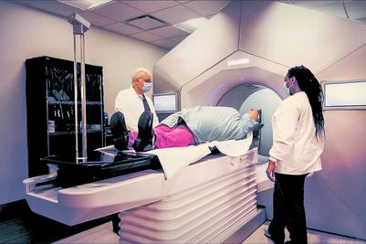 Dr Andrew Satinsky and a radiology tech perform a radiation cancer treatment on a patient at MedStar Southern Maryland Cancer Center.