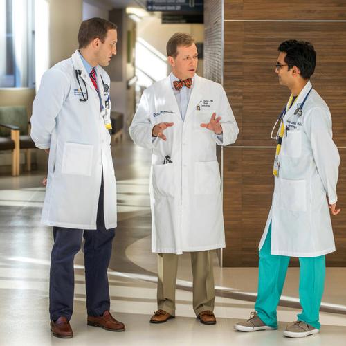 Doctors Brian Case and Allen Taylor talk with a medical student in the lobby at Washington Hospital Center.