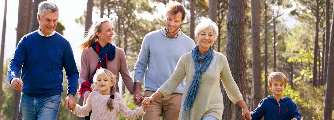 Happy multi-generation family walking in the countryside