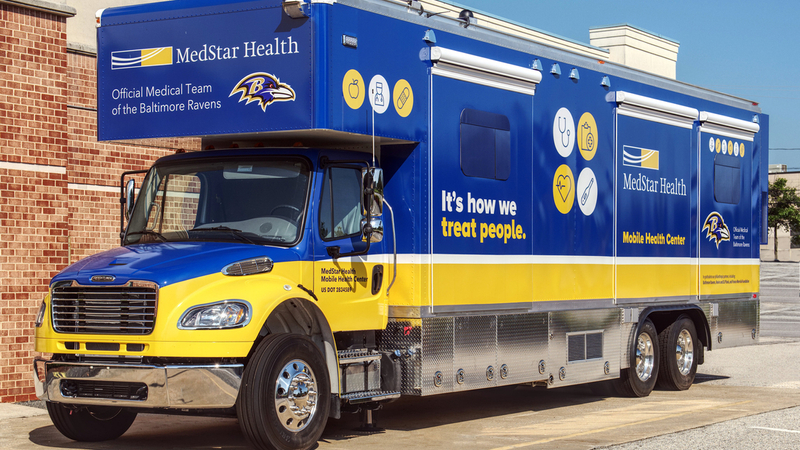 A healthcare provider talks with a patient inside the MedStar Health mobile health truck.