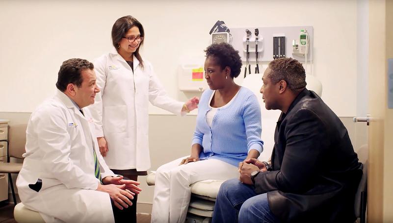 Doctors from MedStar Health talk with a patient and her husband.