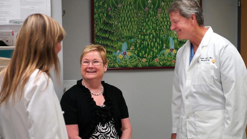 Cathy talks with 2 doctors during a follow-up visit to MedStar Health.