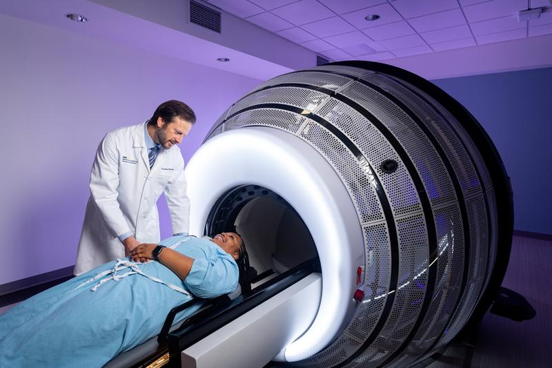 Matthe Witek talks with a patient undergoing treatment in a ZapX machine at MedStar Health.