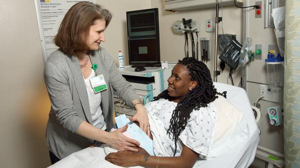 Loral Patchen, MedStar Health midwife, vists with a patient in her hospital room.