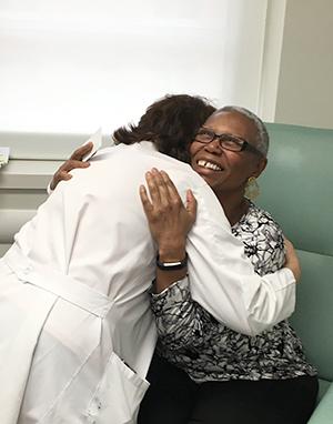 Daisy Diggs hugging Dr. Munshi after learn that her cancer is in “complete remission” thanks to her car-t cell treatment.