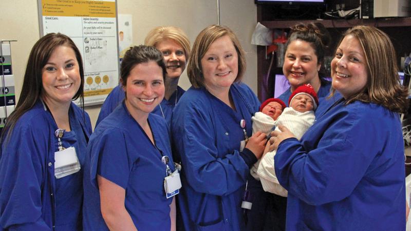 A team of nurses holds 2 newborn babies at MedStar St Mary's Hospital.