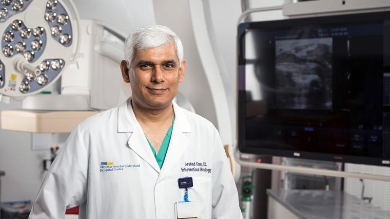 Dr Arshad Khan stands in an interventional radiology lab at MedStar Health.