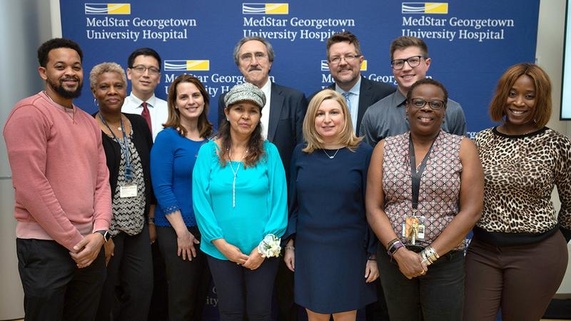 Martha Ramos stands together with her care team at the grand opening of the MedStar Health Proton Center in 2018.