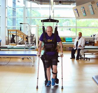 Congressman Steve Scalise walks with assistance during rehabilitation at MedStar National Rehabilitation Hospital.