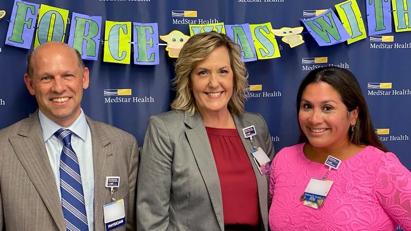 Stuart Levine, Kim Schwenk and Gina Shelly pose for a photo after MedStar Health received a Magnet Designation for Excellence in Nursing.