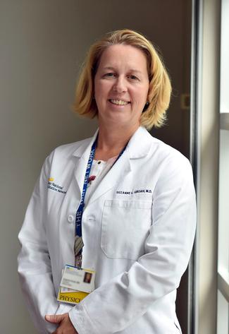 Dr Suzanne Groah poses for a photo in a hallway at MedStar National Rehabilitation Hospital.